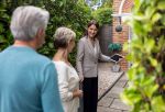 Real estate agent showing a house to a senior couple